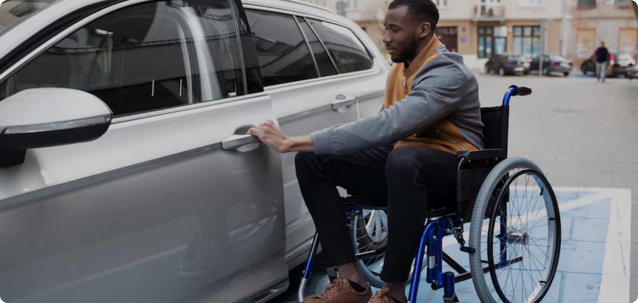 a man on a wheelchair entering a car