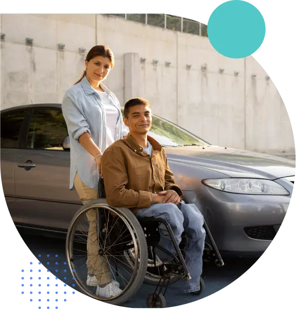 A man in a wheelchair being supported by a lady